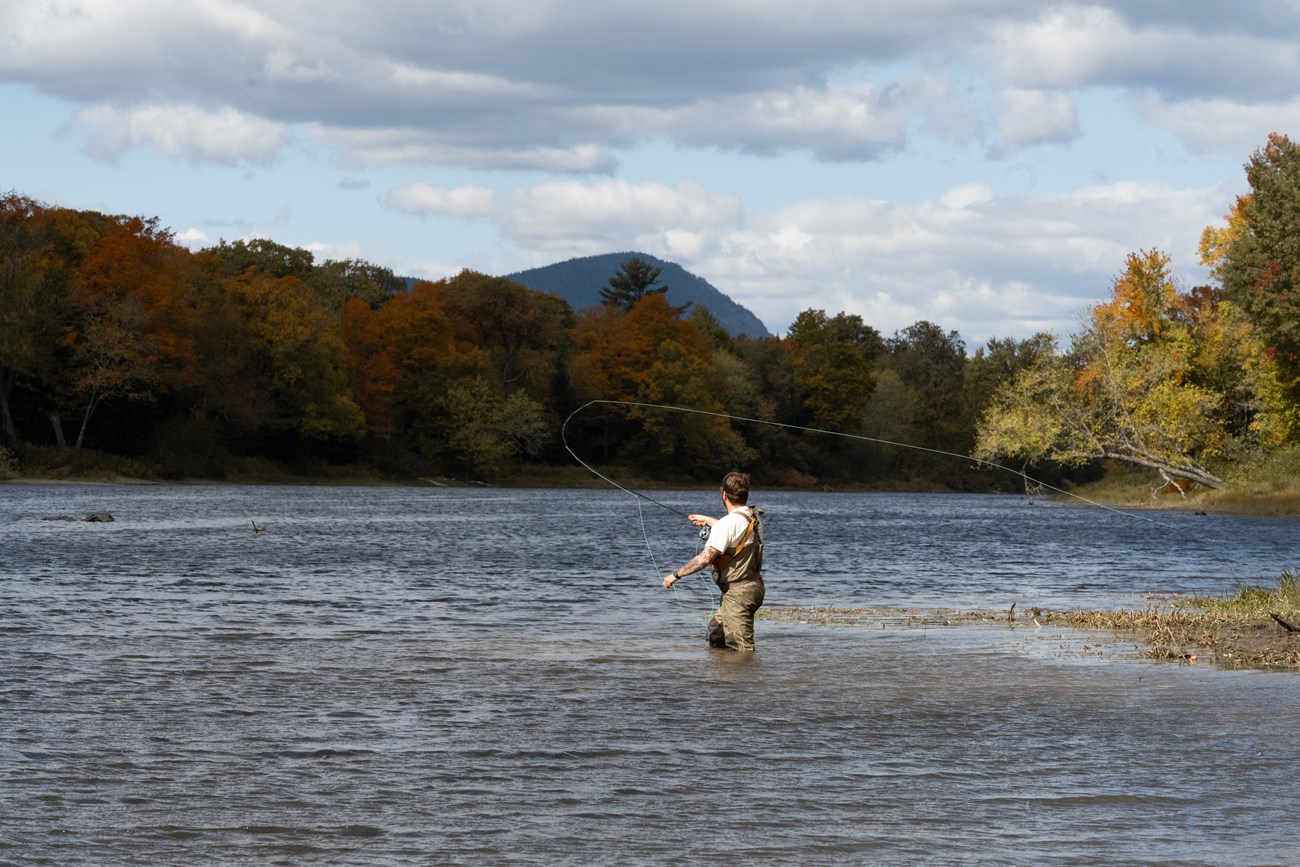 Fisherman fly fishing in the East Branch of the Penobscot river.