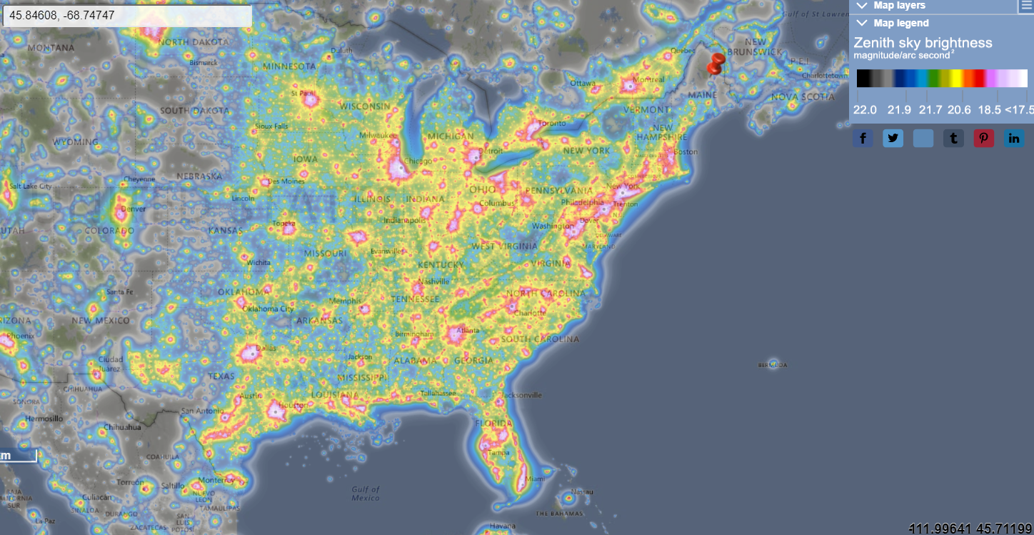 Light pollution map of the east coast of the United States illustrating light pollution. A red pin marks a dark spot in Northern Maine where the monument is located. The color scale indicates there is very little light pollution in this area.