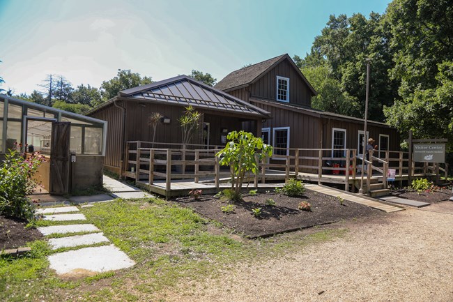 Two buildings directly next to each other with a ramp and connecting porch between the two.