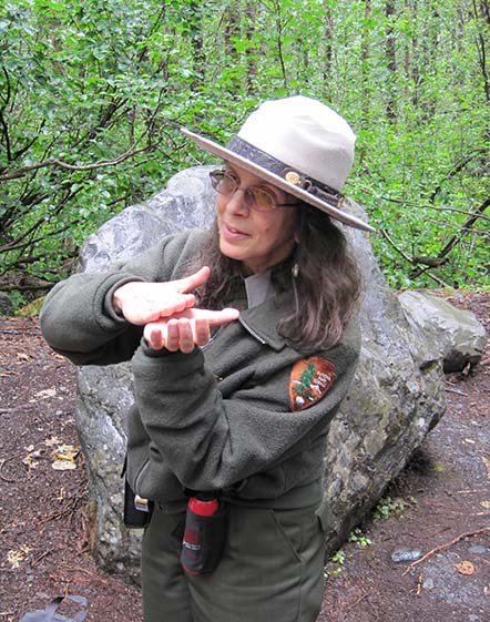 A park ranger talks to visitors while hiking along the park trails.