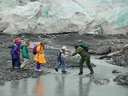 Ranger helping students across Exit Creek