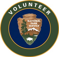 NPS VIP Logo. Arrowhead logo on navy blue background surrounded by green circle outlined in yellow.