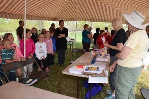 A group of students listens to two speakers.