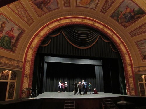 A group of students stand on a large stage.