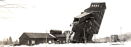 Historic photo: An abandoned shaft-rockhouse meets its fate in January 1966. Keweenaw NHP Archives, Jack Foster Collection