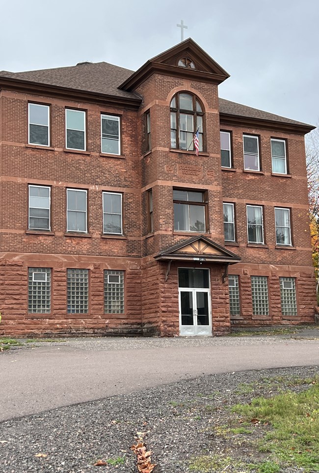 A historic three-story brick building, previously a Catholic school.