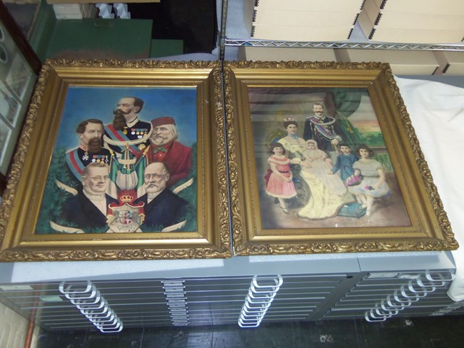 Hand-colored prints depicting the founders of the modern Italian state and the Italian royal family are shown at the Keweenaw NHP museum facility in Calumet, and hanging on either side of the stage at the Italian Hall the day after the disaster.