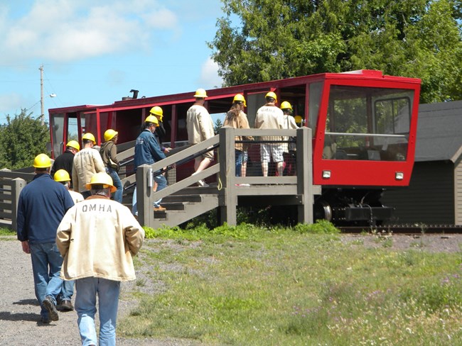 Visitors prepare to travel down the hill on the Quincy tram.