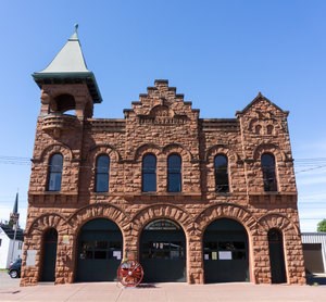 The exterior sandstone structure of the Copper Country Firefighters History Museum.