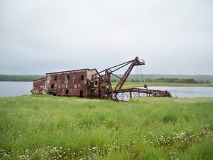 The rusted remnants of the Quincy Dredge sitting in Torch Lake.
