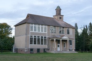 The gray exterior of the Gay Schoolhouse.