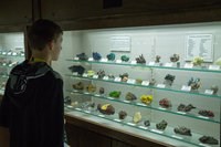 A student explores a diverse array of mineral specimens.
