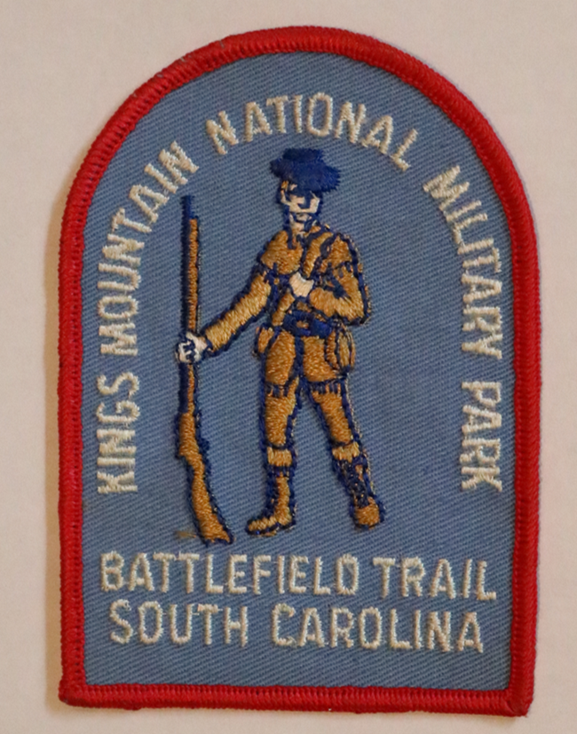 A patch with a soldier and Battlefield Trail Award on it and Kings Mountain National Military Park