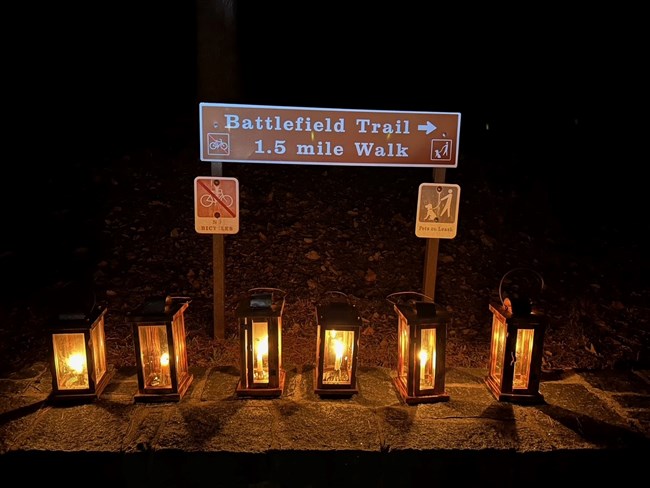 6 Lanterns are shown at night with a sign stating "Battlefield Trail 1.5mi loop