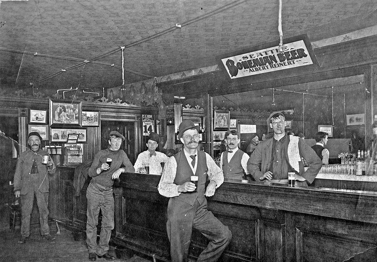 six men stand in a bar