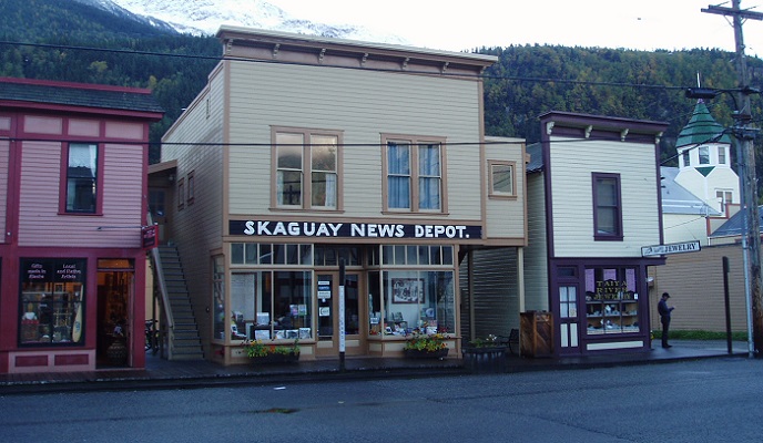 Colorful buildings containing businesses line a street.
