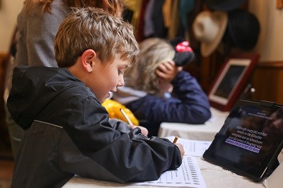 child uses an iPad to learn gold rush history