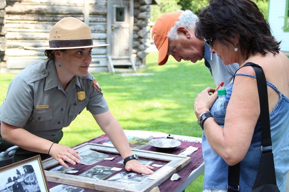 Park Ranger talks to visitors at an outdoor table