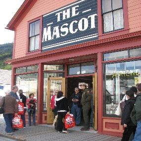 Modern photo of The Mascot saloon museum with ranger talking to visitors