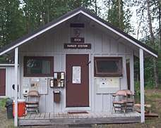 Small cabin with sign above the door reading "Ranger Station."