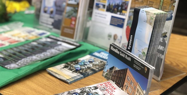 Printed materials on a table available for visitors at a community event.