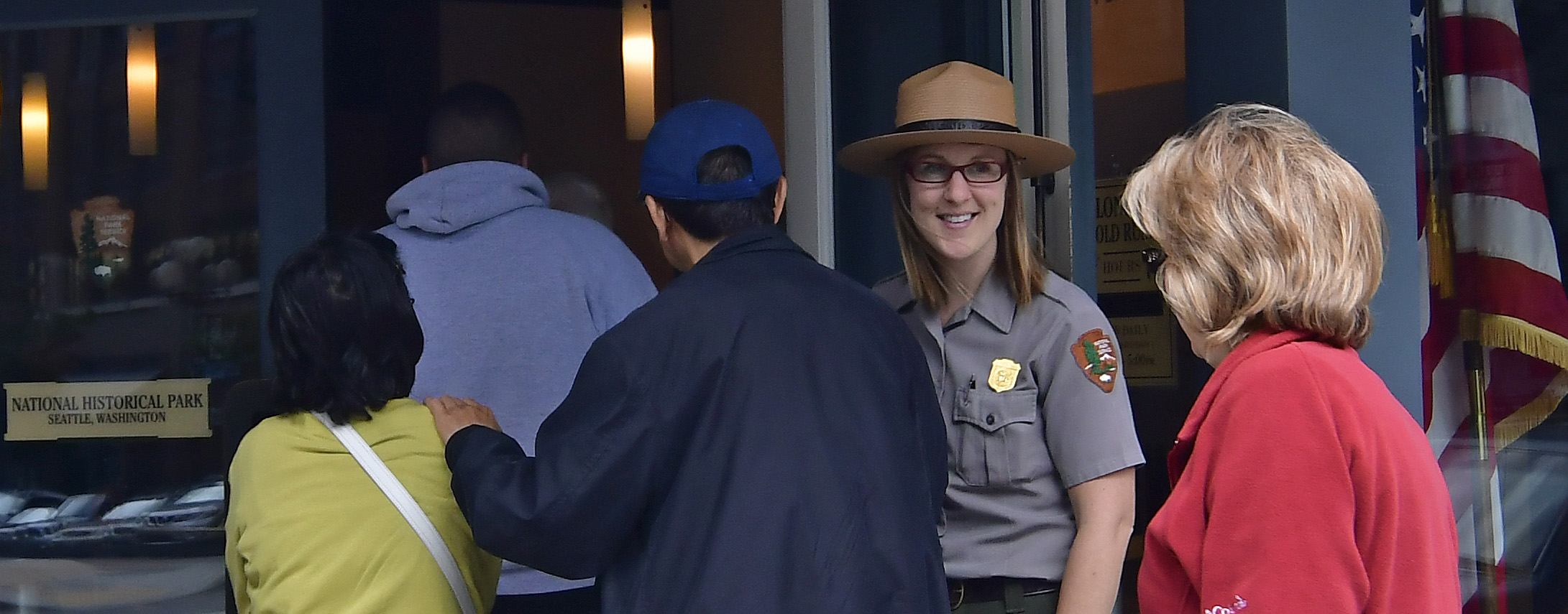 Ranger in uniform speaking to a group of visitors.