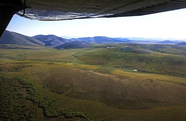 aerial view of the tundra with plane wing in the corner