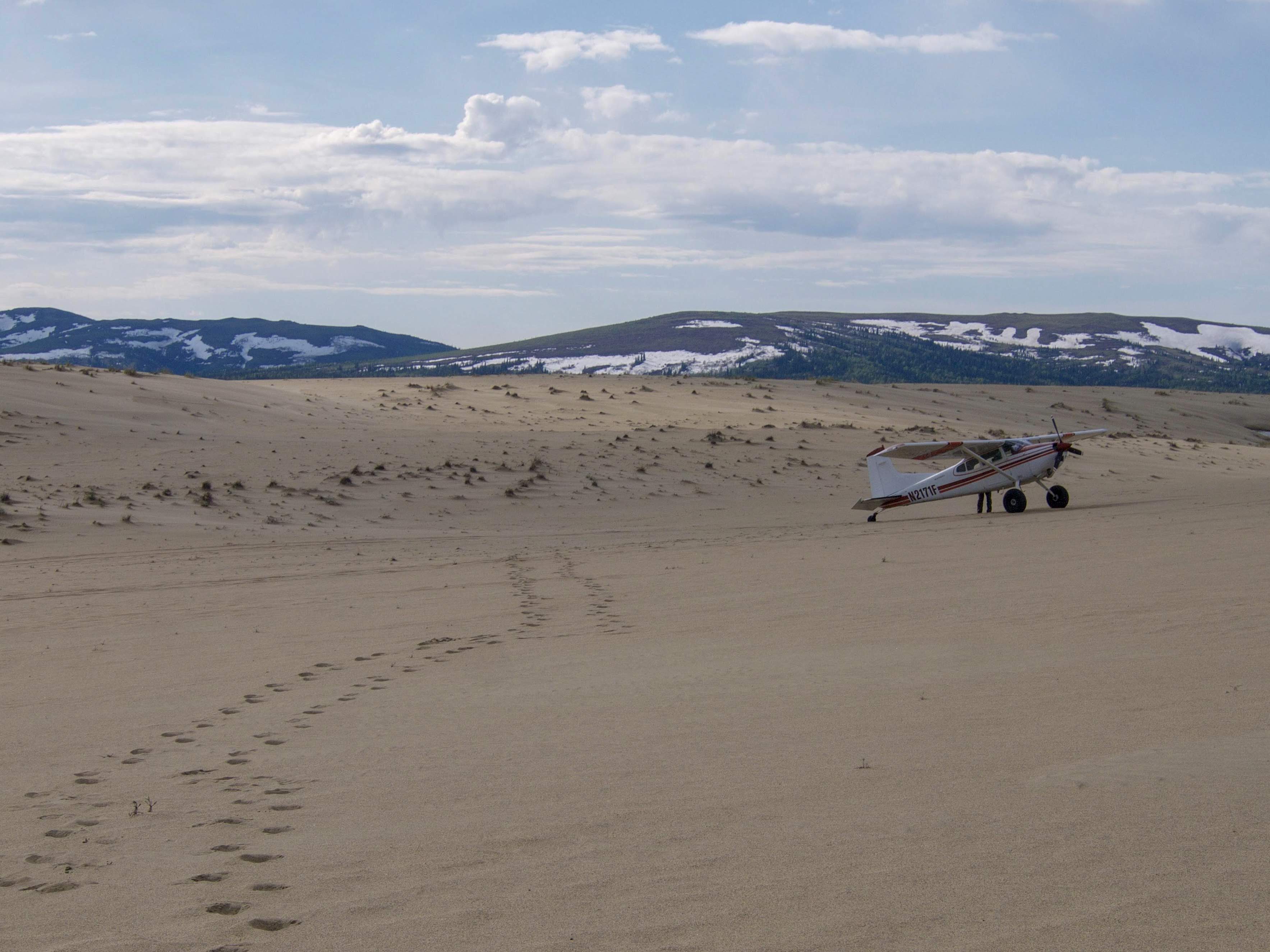 An NPS plane sits on the Great Kobuk Sand Dunes.