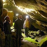 Visitors explore a cave