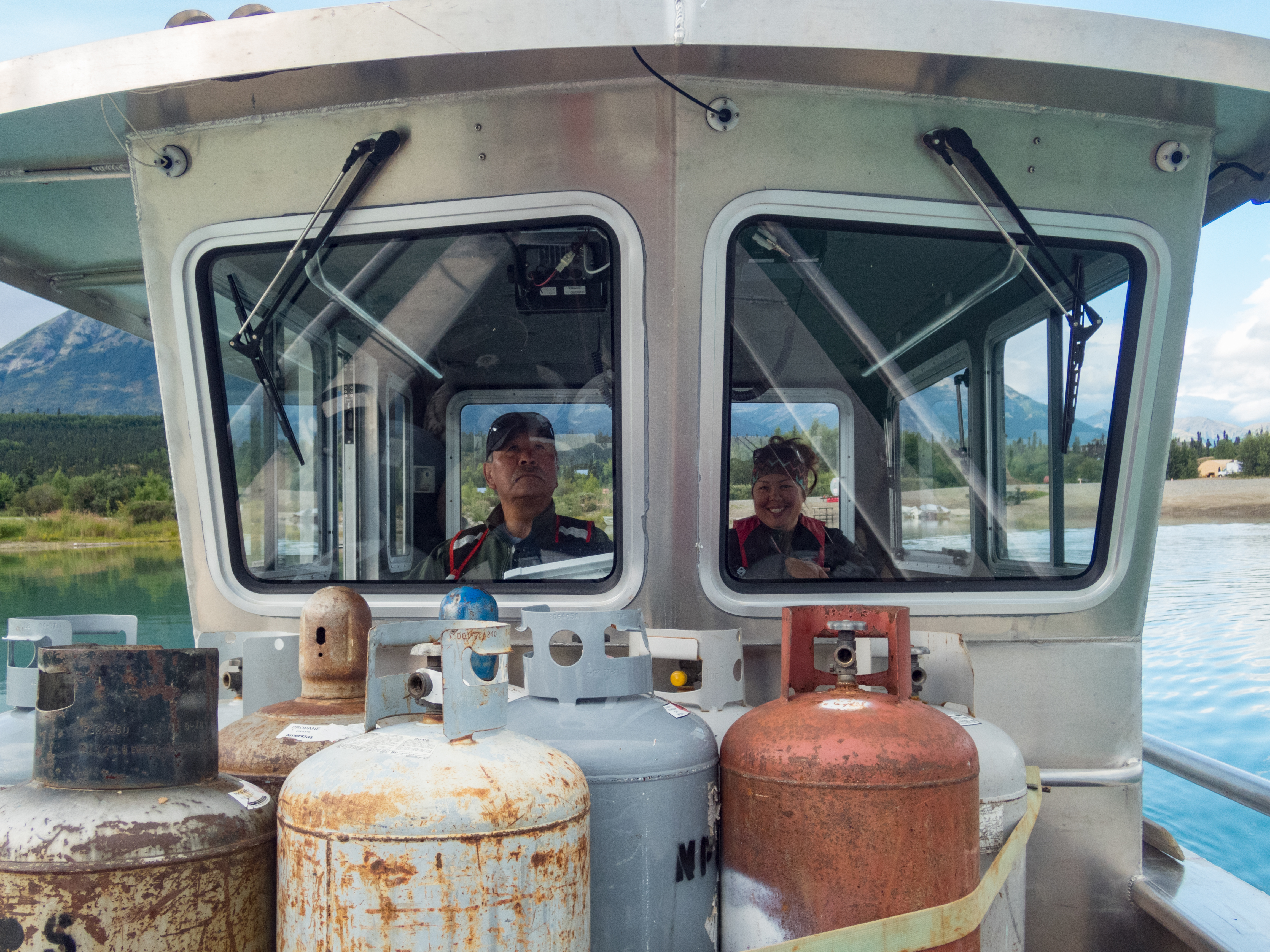 a man and a woman in the cab of a large boat