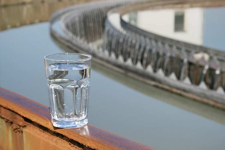 A glass of water sits at a treatment facility