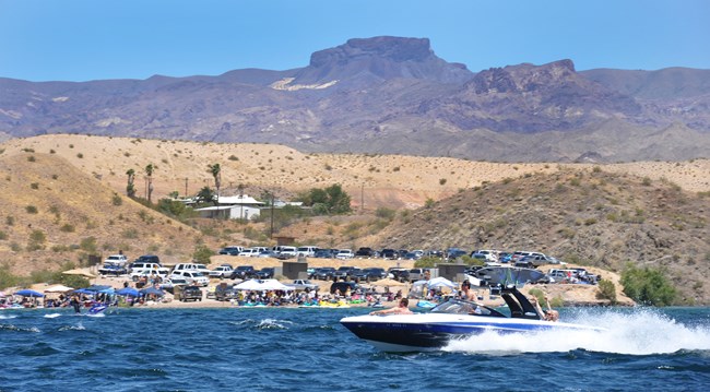 Boating past beach on Lake Mohave