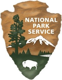 Icon of arrowhead with a redwood tree, snow-covered mountain, and bison, and words National Park Service