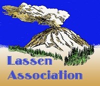 A volcano with smoke rising from the summit with the words "Lassen Association."
