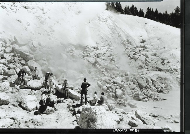 historic image of a ranger talking to a group of visitors at a hydrothermal vent