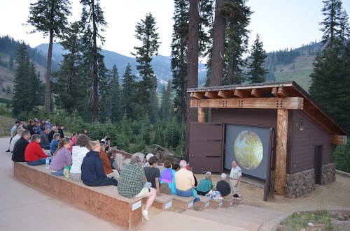 A ranger gives a presentation in an outdoor amphitheater
