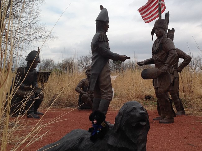 stuffed pup with statue