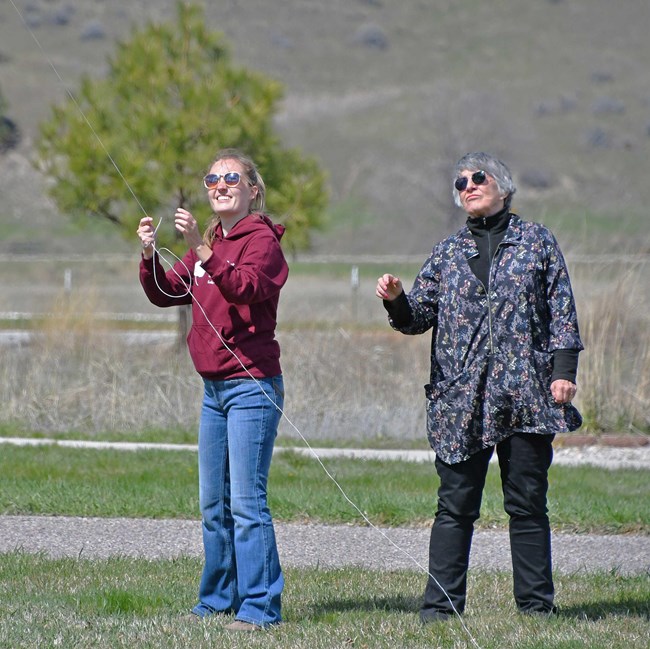 two women flying a kite