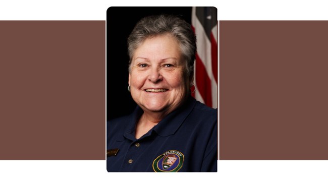 portrait of woman with short grey hair and a NPS volunteer polo.