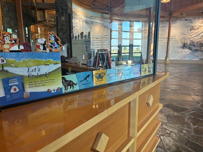 a visitor center desk with colorful stickers on display