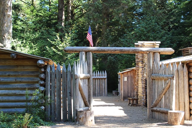 Fort Clatsop Exhibits of pointed pallisaids surrounding two small rows of huts.