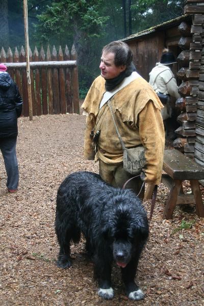 Ranger in busckskins with newfoundland at fort in the rain