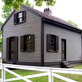 1 story light gray house with dark gray trim