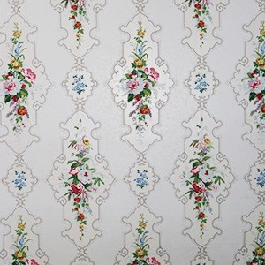 White wallpaper with repeating vertical pattern of shapes outlined in gray, with clusters of pink, white, and blue flowers in middle of shapes