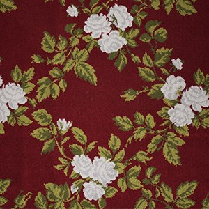 deep red carpet with pattern of two toned green leaves and clusters of white flowers forming square diamond pattern
