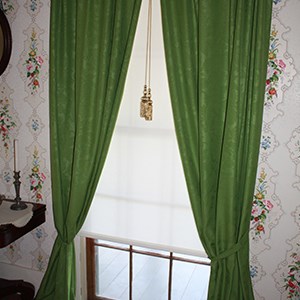 Green sill-to-floor curtains with faint design