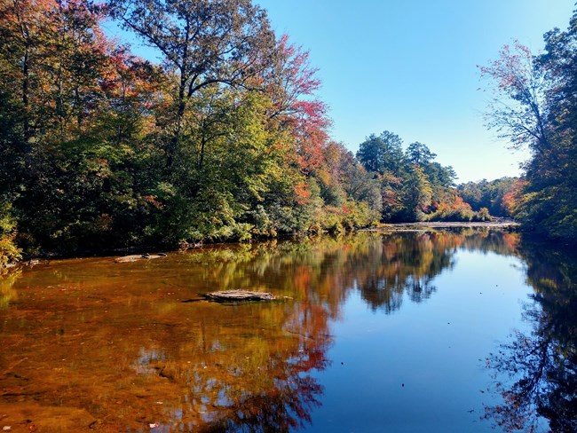 Blue Hole, a calm spot in the river with fall color beginning to show on the trees.