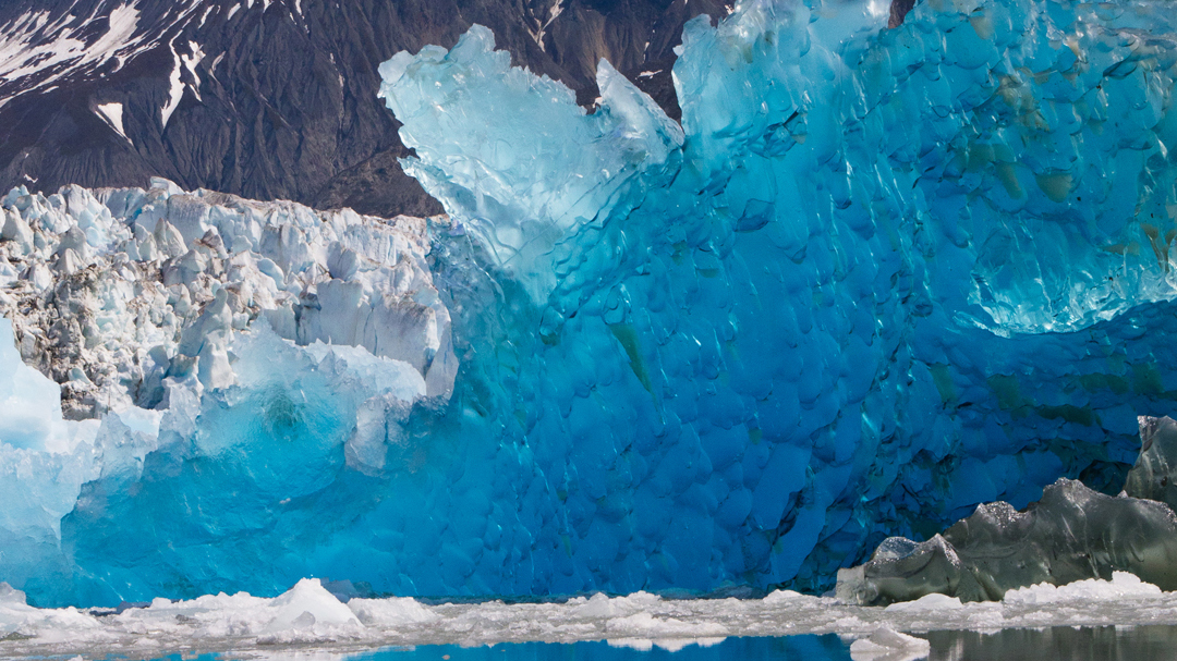 Blue Glacial Ice juts out in a jagged formation.