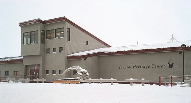 Image of a tan colored building. The building is mostly one level, but there is a small section that appears to be two floors.