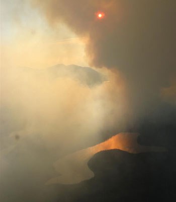 Smoke paints the sky eerie hues and shrouds the sun, Wrangell-St. Elias NP Chakina Fire, 2009